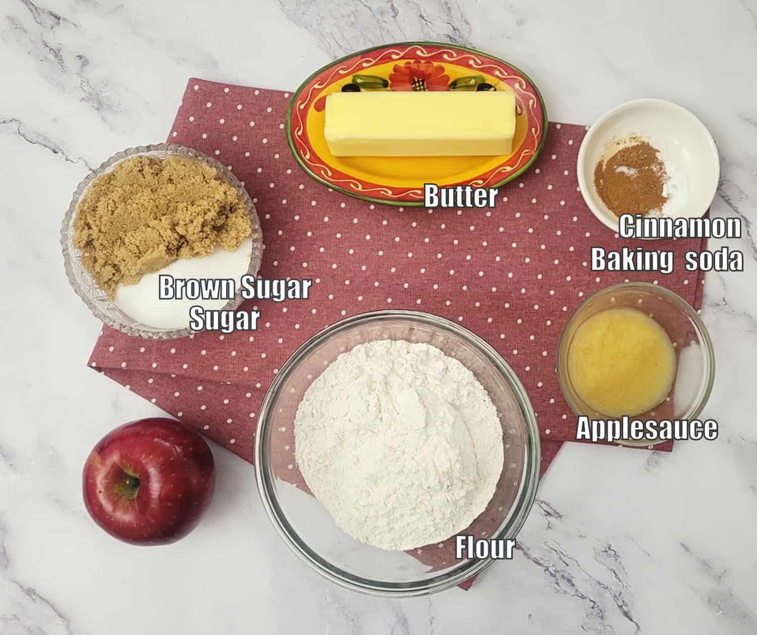 ingredients needed to make the eggless apple cookie recipe including flour, apple, applesauce, granulated sugar, brown sugar, baking soda, cinnamon and butter