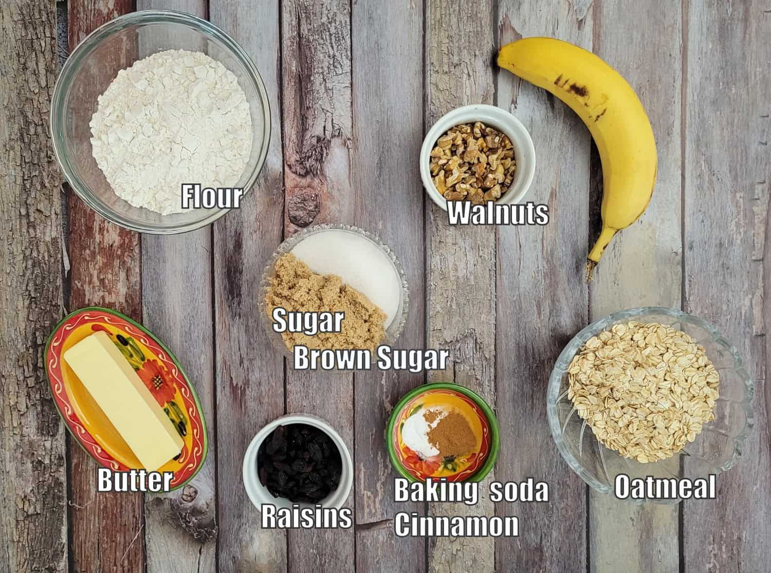 ingredients needed for eggless oatmeal cookie recipe including oatmeal, flour, butter, banana, brown sugar, granulated sugar, baking soda, cinnamon, walnuts and raisins