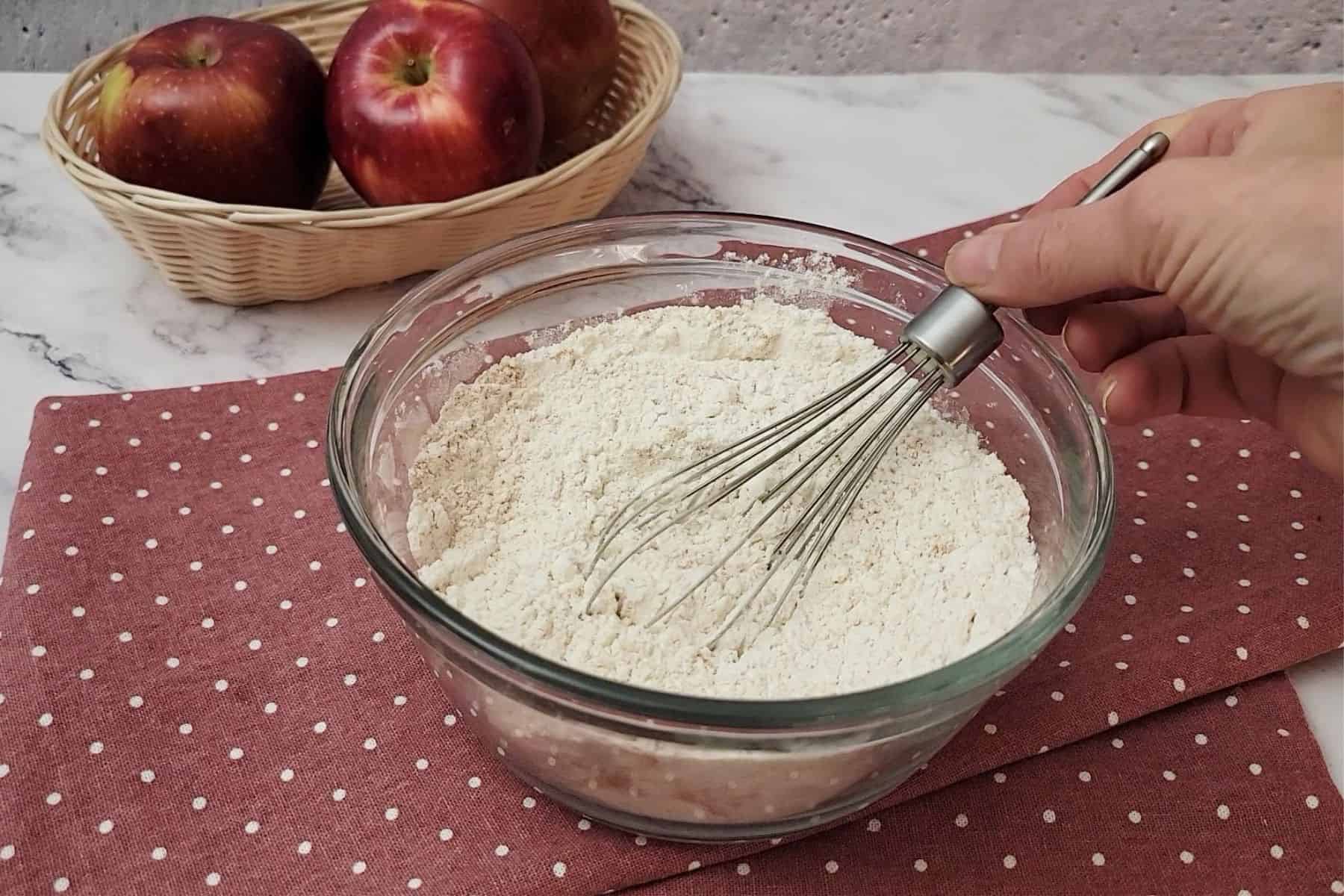 whisking together flour, baking soda and ground cinnamon in a mixing bowl