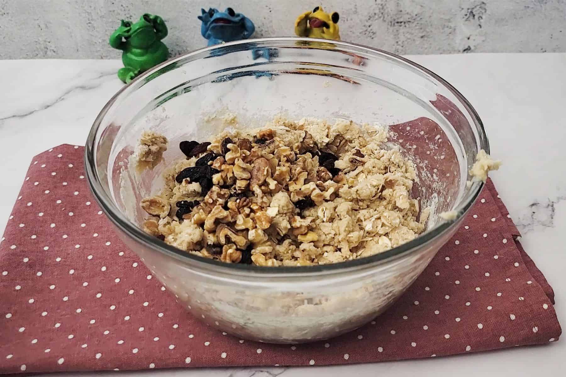 walnuts and raisins added to bowl with eggless cookie dough