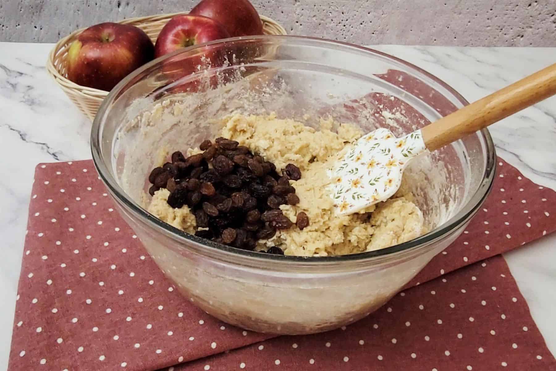 raisins added to mixing bowl with eggless apple cookies recipe dough