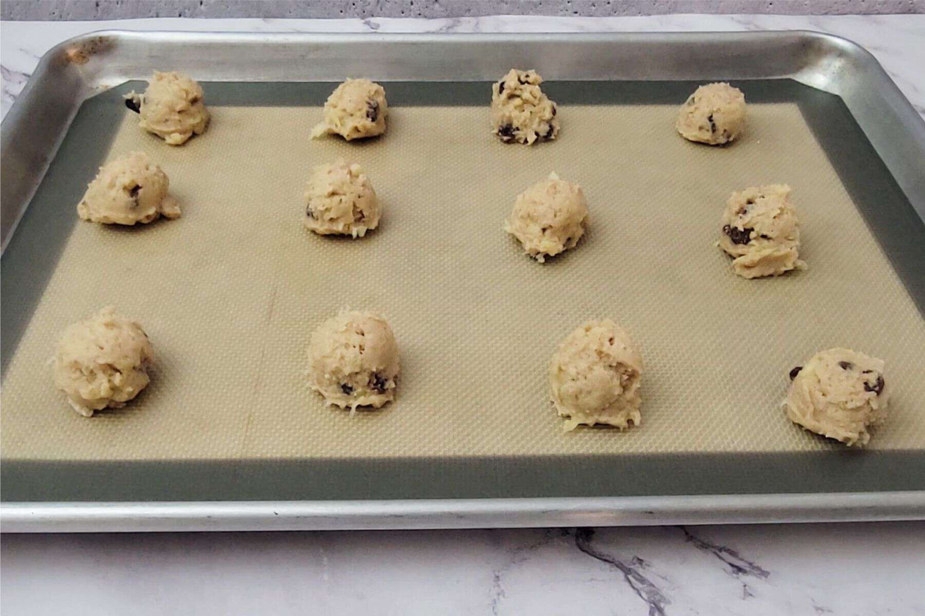 apple cookie dough made without eggs scooped onto baking sheet