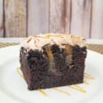 slice of chocolate poke cake with caramel filling