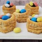 Five puff pastry Easter egg nests on a serving platter
