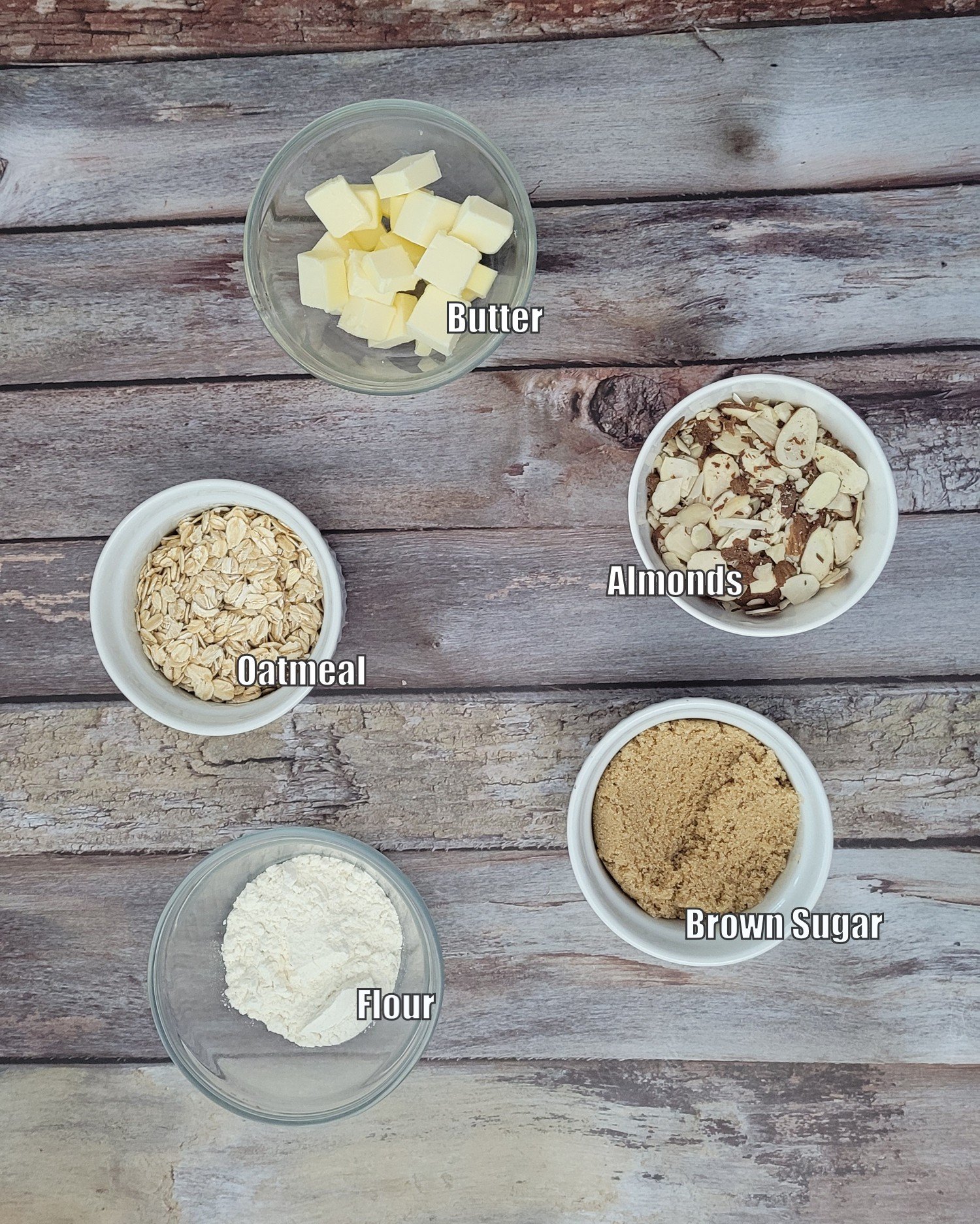 ingredients needed to make almond crumble topping including brown sugar, flour, almonds, oatmeal and butter