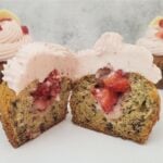 inside of a banana cupcake with strawberry filling and frosting