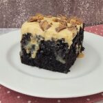 slice of chocolate peanut butter poke cake on a plate