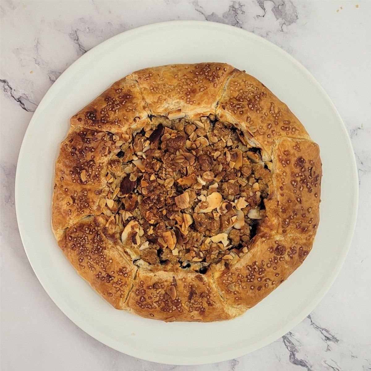 overhead view of a baked rustic blueberry almond galette dessert