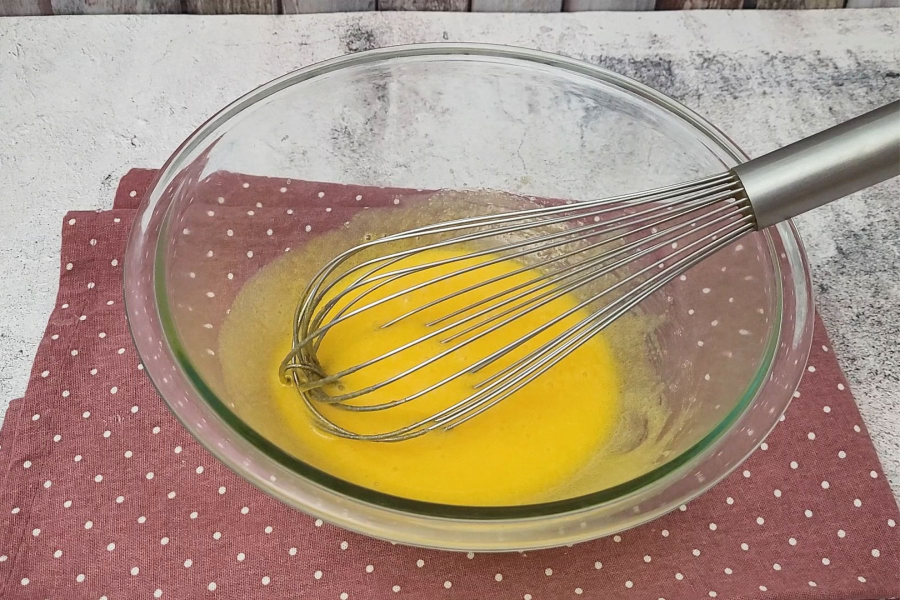 eggs and sugar whisked together in a bowl