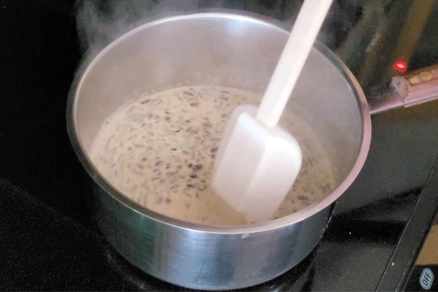 cream for coffee crème brulee in a saucepan simmering over a stovetop