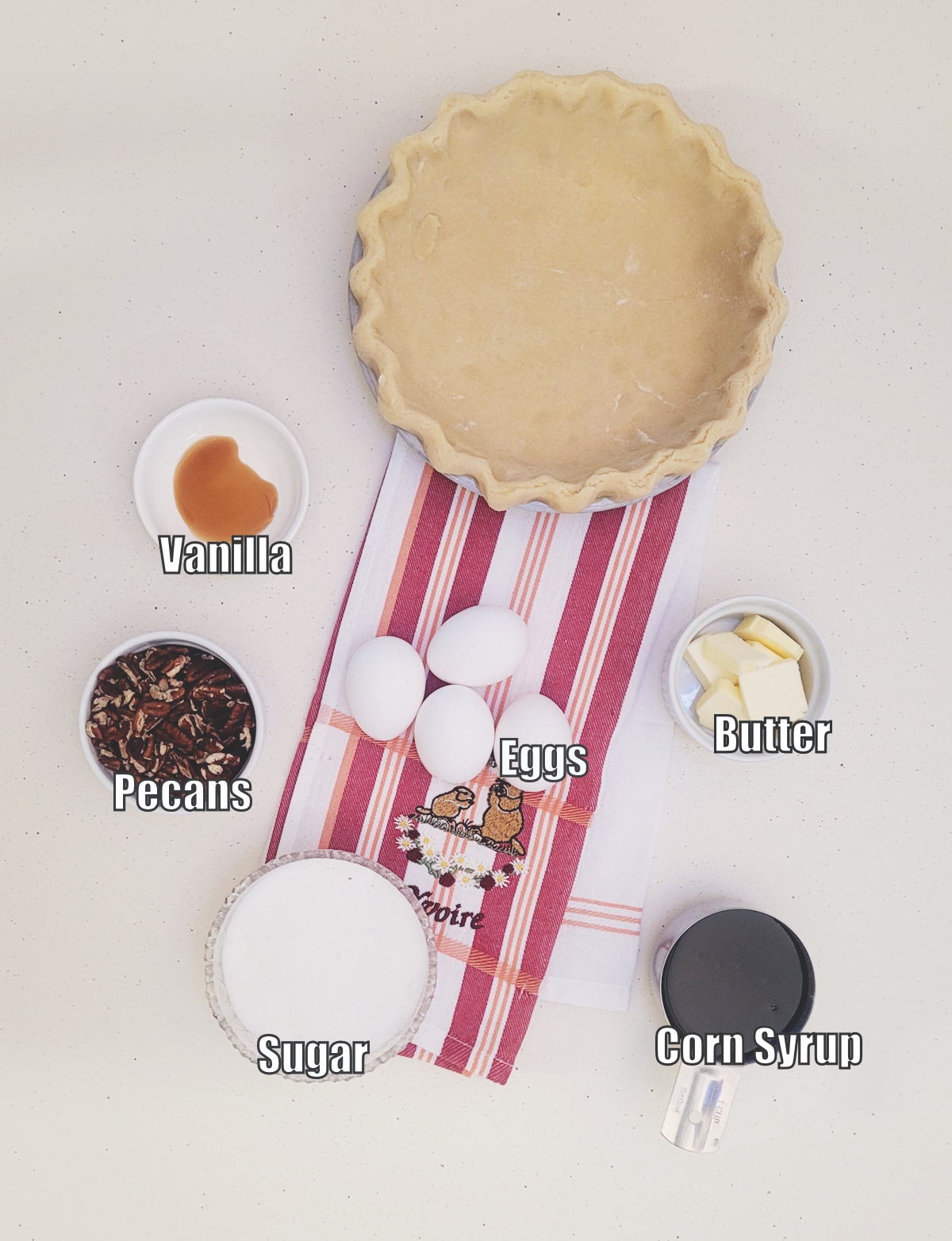 ingredients needed to make a pecan pie that isn't runny including sugar, corn syrup, pie crust, eggs, butter, pecans and vanilla extract