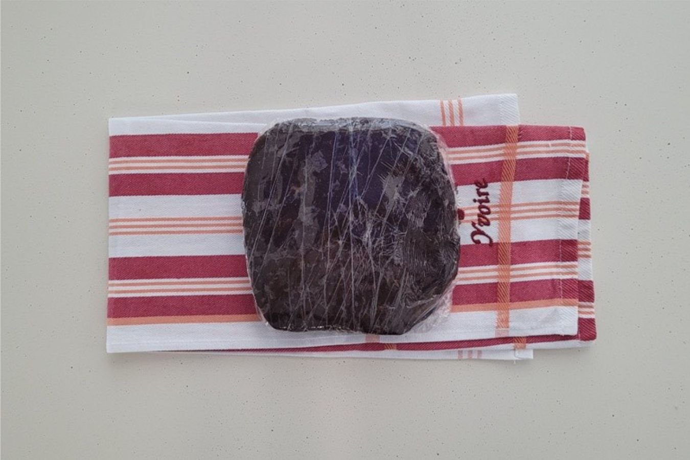 chocolate cookie dough wrapped in plastic before chilling
