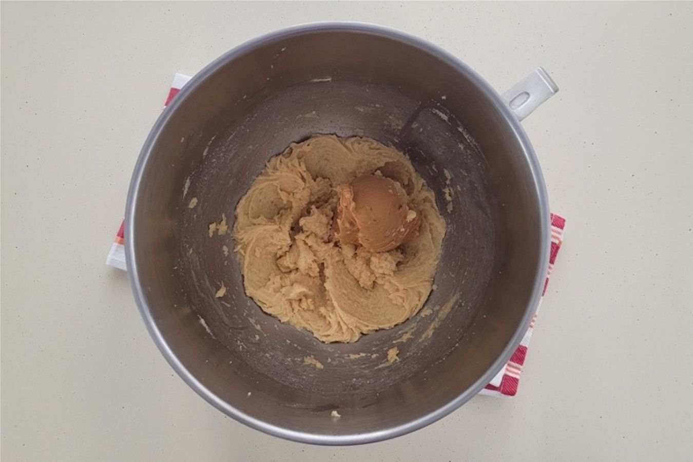 chunky peanut butter added to mixing bowl to make cookie dough