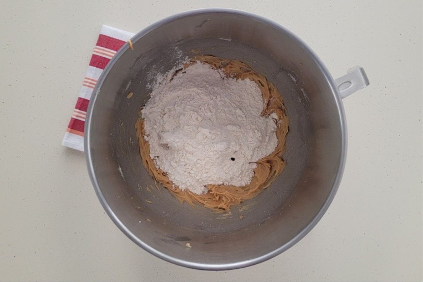 dry ingredients added to mixing bowl to make peanut butter dough portion of cookies