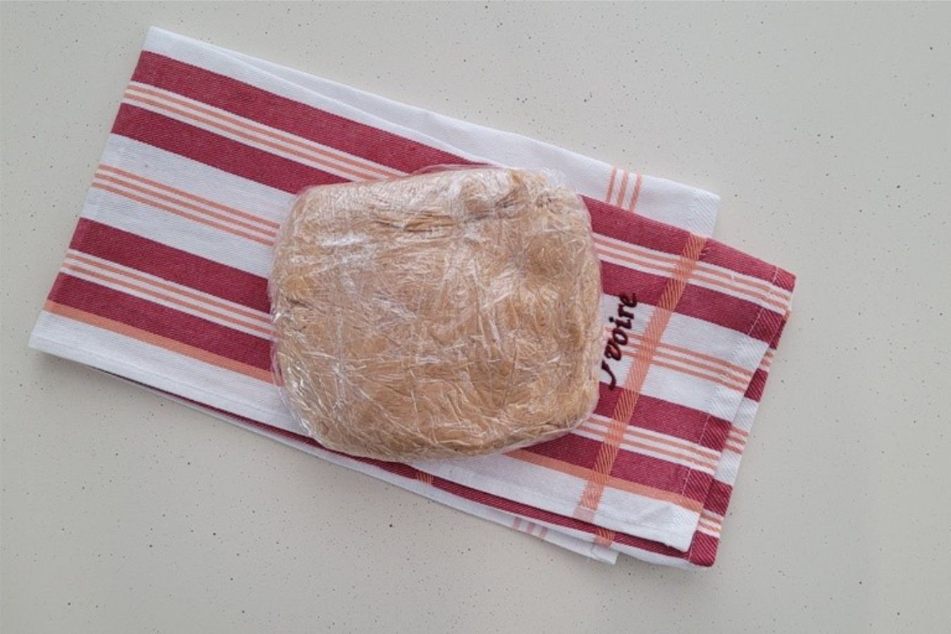 peanut butter cookie dough wrapped in plastic before chilling