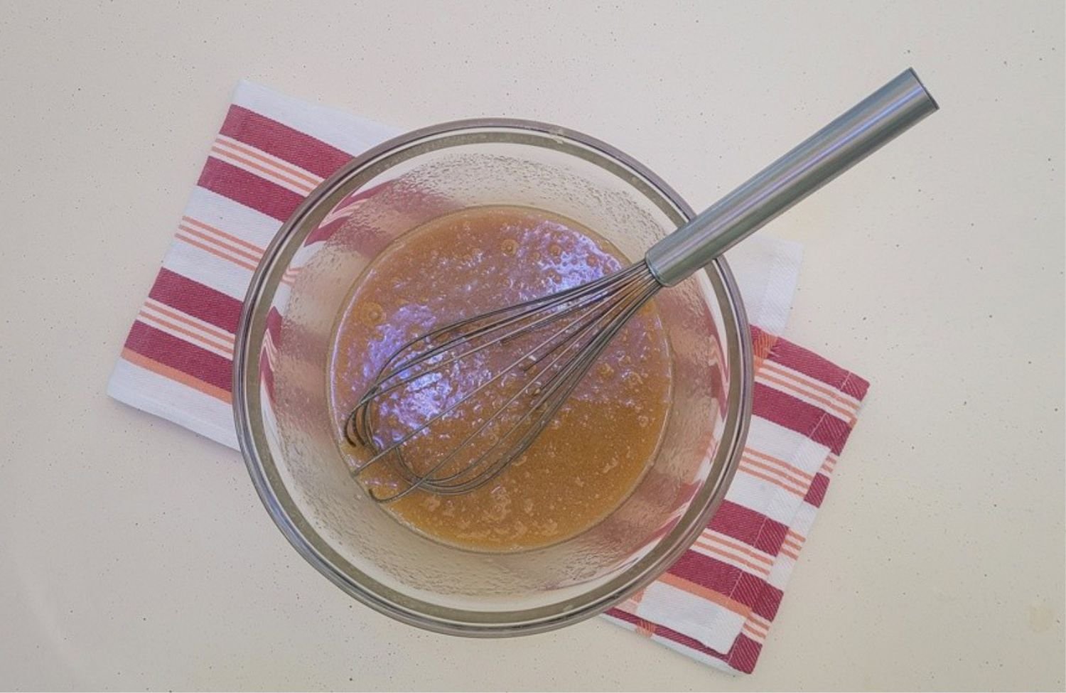 pie filling ingredients mixed together with a whisk in a glass bowl