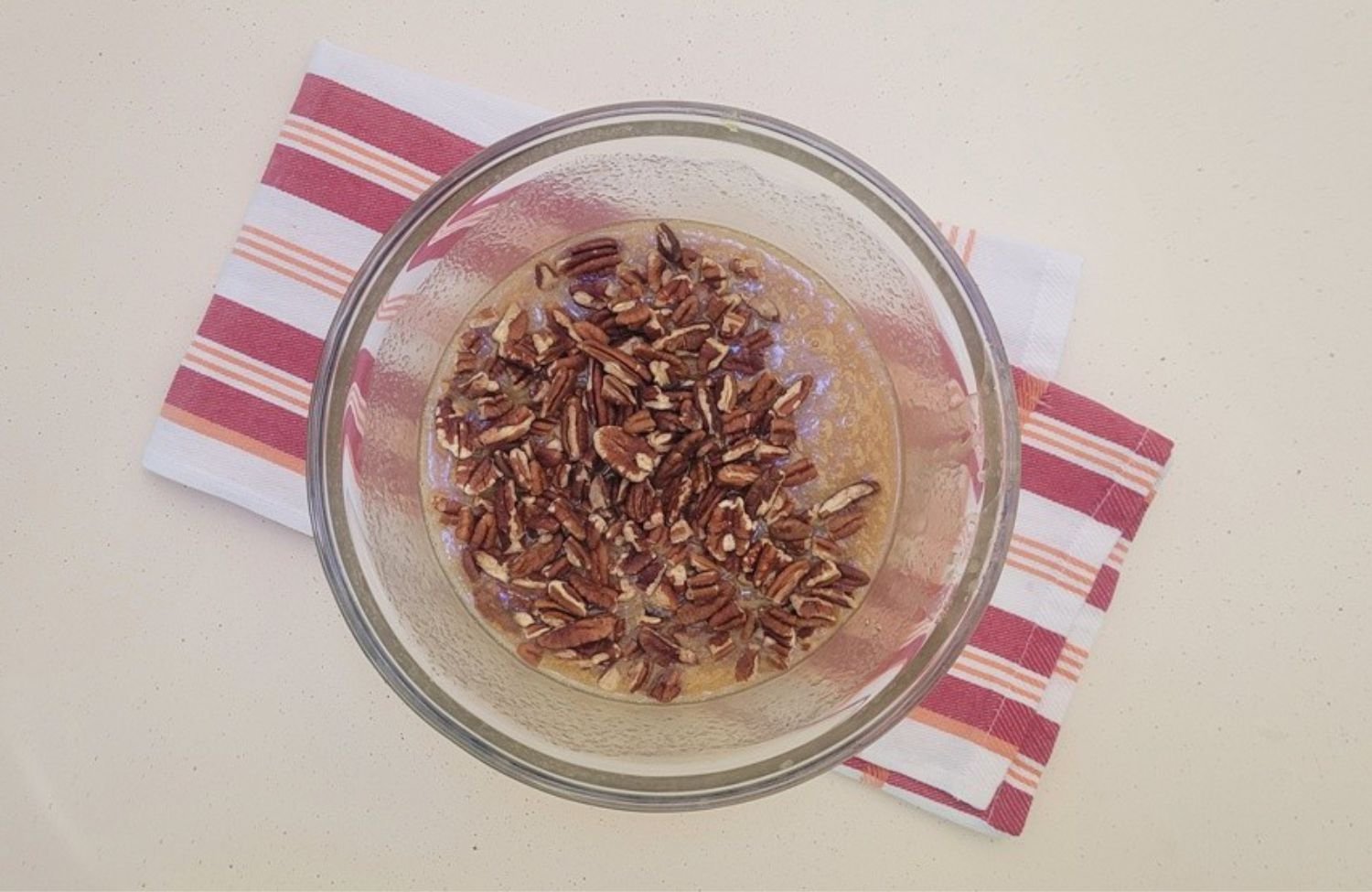 pecans added to mixing bowl as final step in creating pie filling