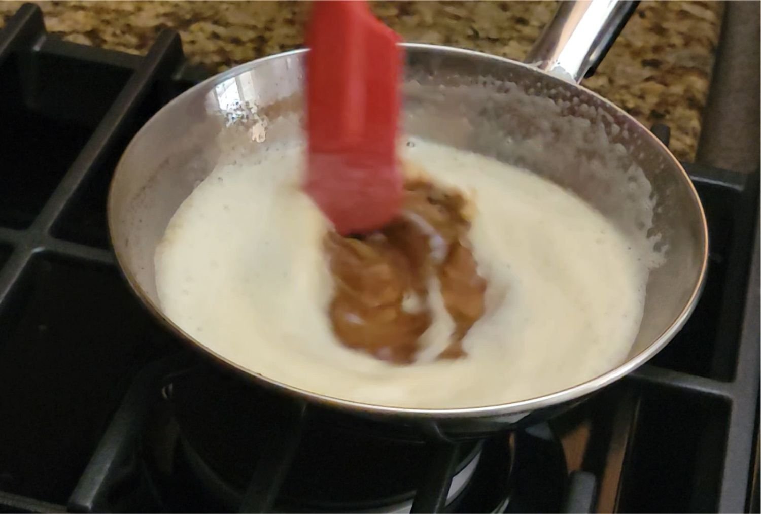 stirring browned butter in a saucepan over stovetop