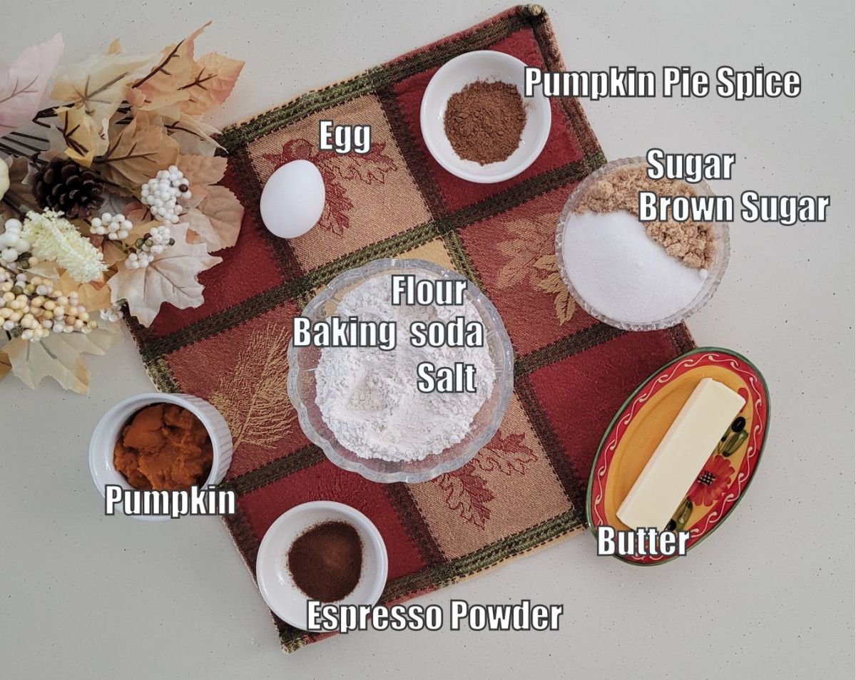 ingredients needed to make pumpkin latte cookie recipe including butter, espresso powder, pumpkin puree, baking soda, salt, all-purpose flour, pumpkin spice, brown sugar, granulated sugar and an egg
