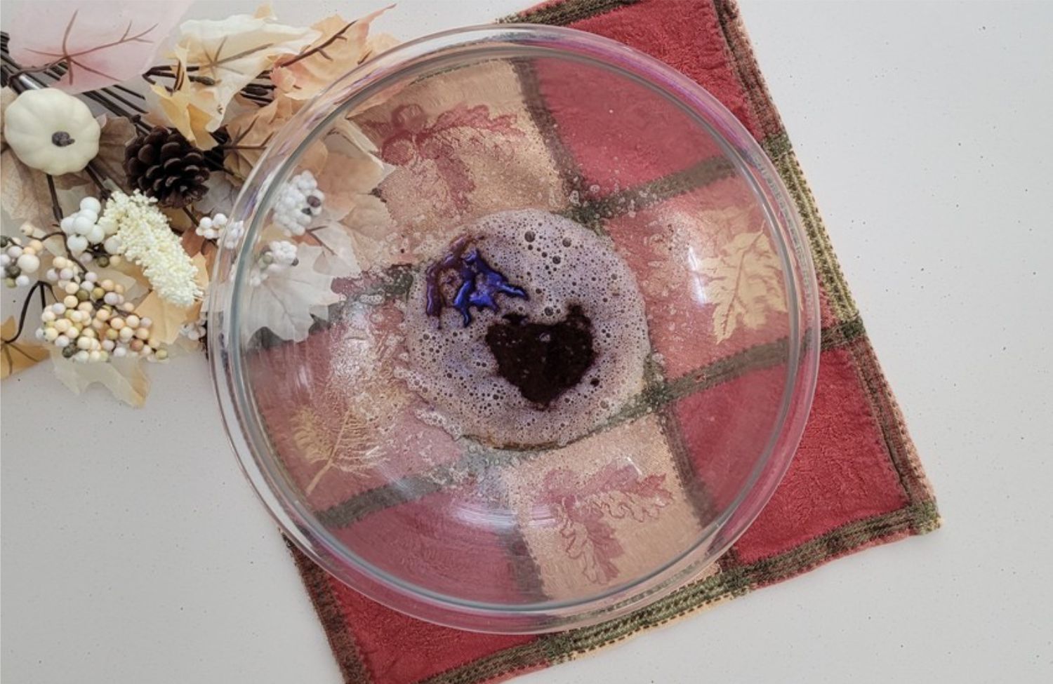 overhead view of browned butter poured into a glass mixing bowl