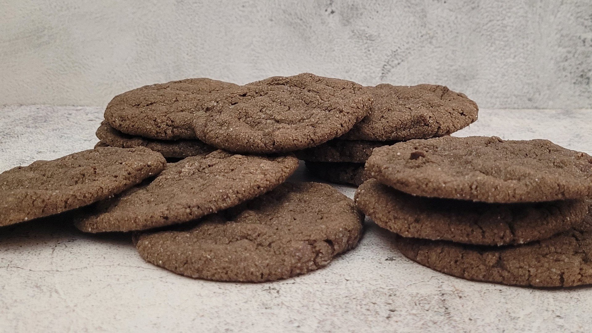 several crispy gluten free chocolate cookies on a countertop