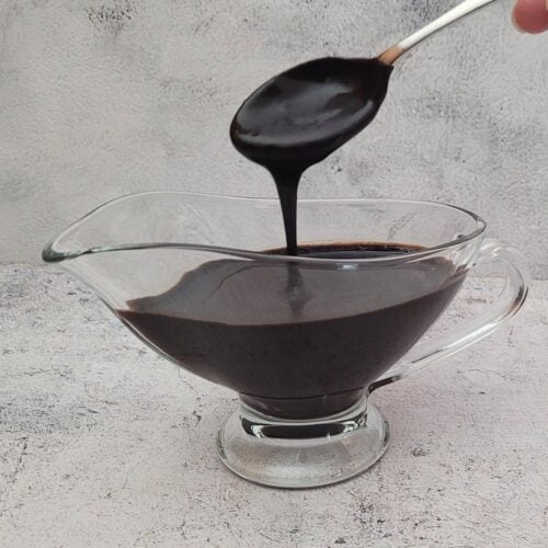spoon drizzling chocolate sauce into a serving dish