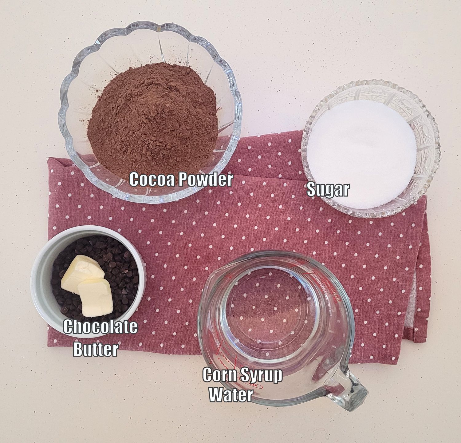 ingredients needed to make homemade chocolate sauce including corn syrup, water, chocolate, butter, cocoa powder and granulated sugar