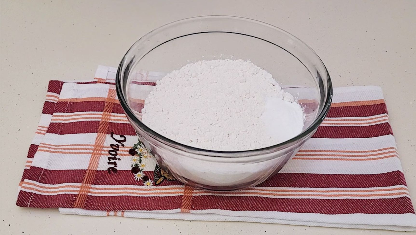 flour, baking powder, baking soda and salt combined in a glass bowl