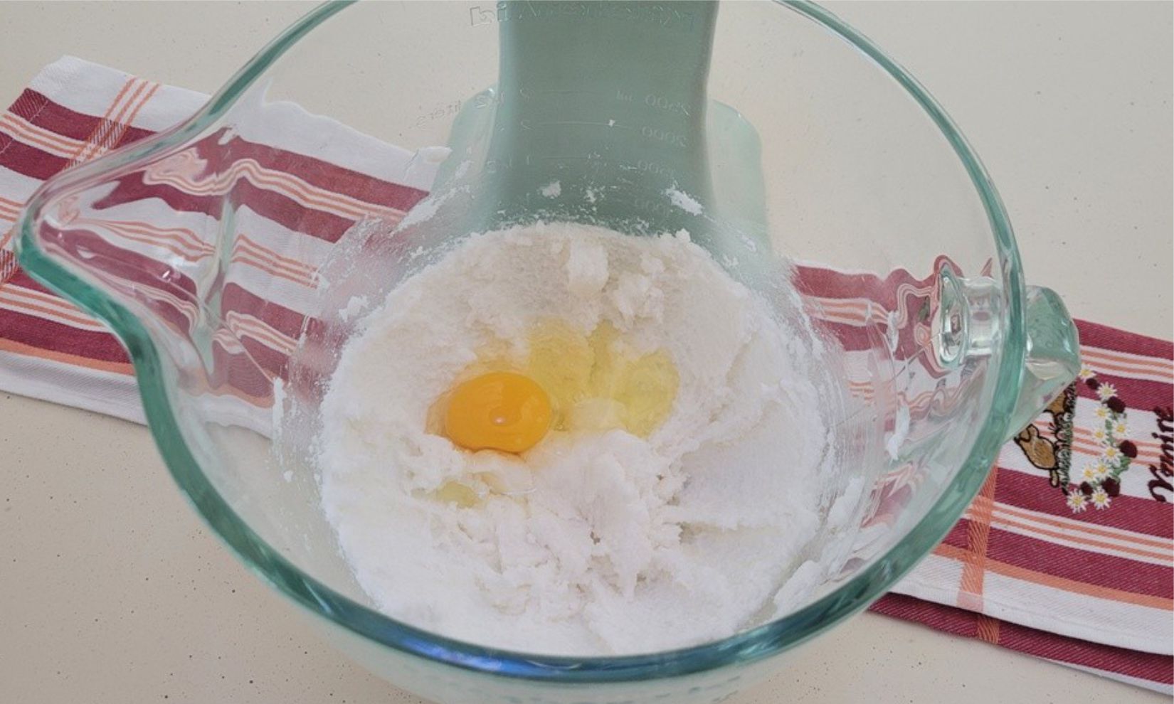 egg added to mixing bowl with vegetable shortening and granulated sugar