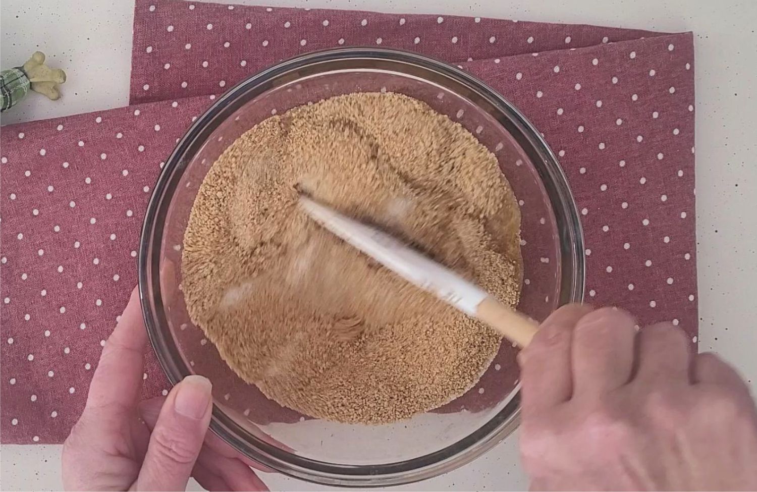 stirring together graham crackers, sugar and butter to make crust