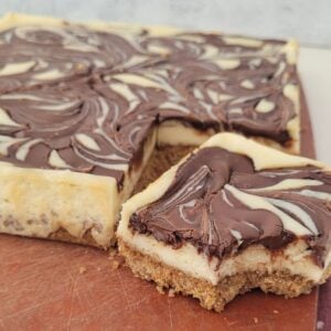 close up photo of Nutella cheesecake bars on a cutting board