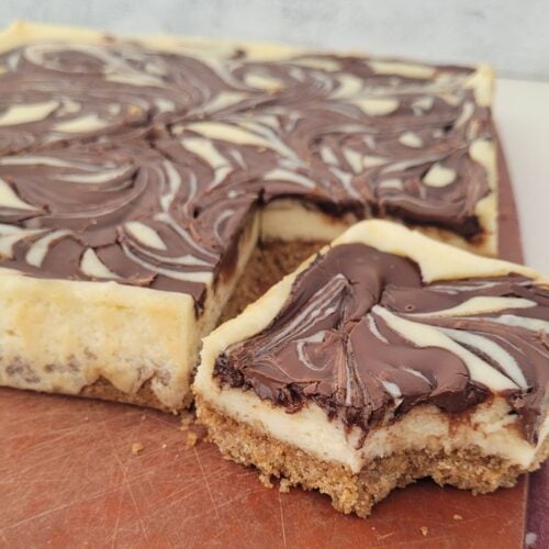 close up photo of Nutella cheesecake bars on a cutting board