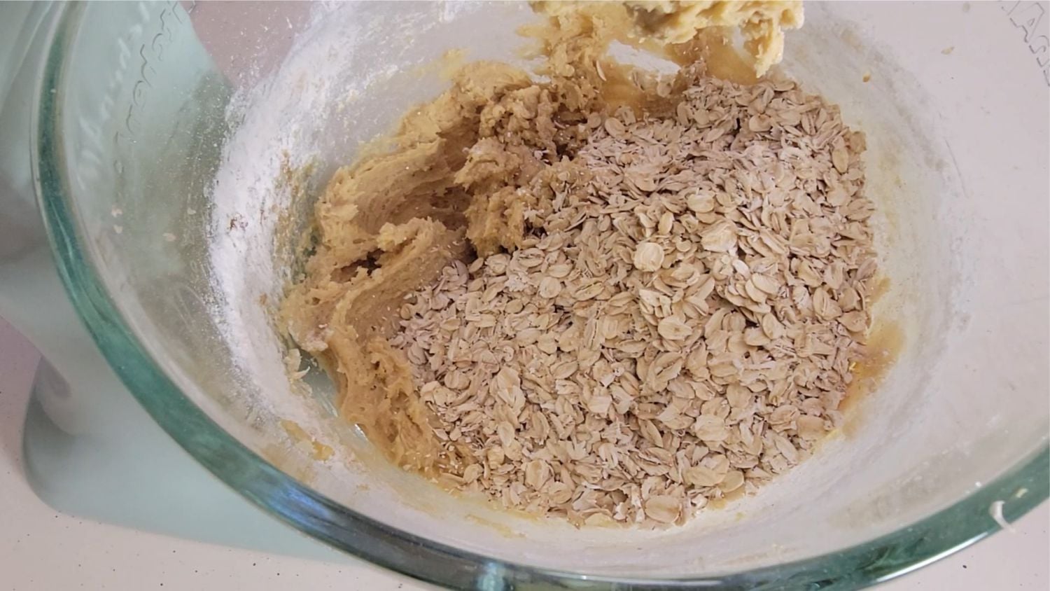 oatmeal added to mixing bowl to make cookie dough for GORP cookies recipe