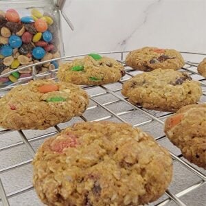 GORP cookies on a cooling rack with a jar of GORP in the background